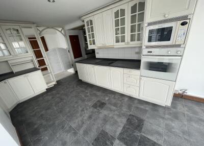 Modern kitchen with white cabinetry and tiled flooring