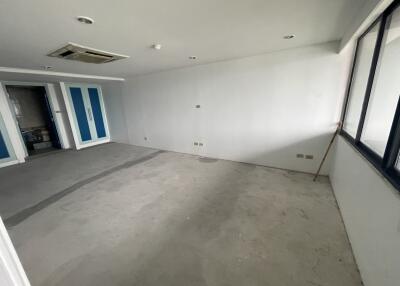 empty bedroom with large windows and blue closets