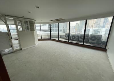 Spacious living room with large windows and city view