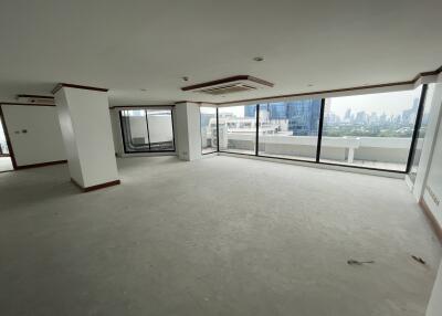 Spacious living area with large windows and city view