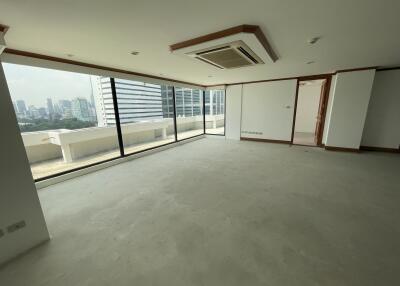 Spacious living room with large windows and city view