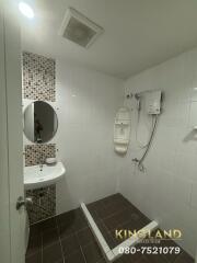 Modern bathroom with shower, sink, and tiled wall