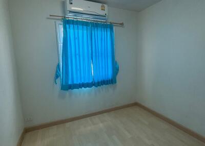 empty bedroom with blue curtains and air conditioning