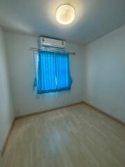 empty bedroom with blue curtains and air conditioning