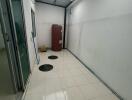 Covered utility area with tiled flooring and storage space