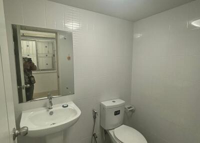 Modern bathroom with white tiles and toilet