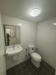 Modern bathroom with white tiles and toilet