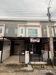 Front view of a townhouse with a gated carport