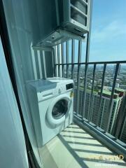 Balcony with washing machine and city view