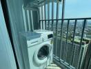 Balcony with washing machine and city view