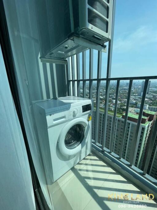 Balcony with washing machine and city view