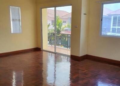 Spacious living room with hardwood floor and sliding glass doors