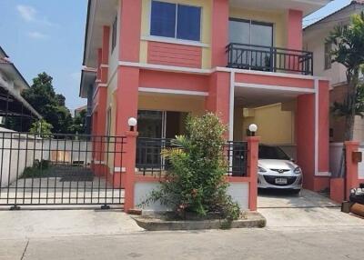 Exterior view of a two-story house with a car parked outside