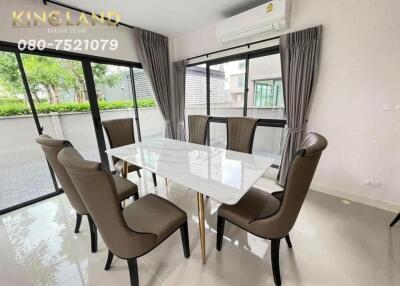 Modern dining room with glass table and six chairs