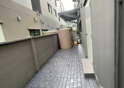 side alley with paved flooring and utility features