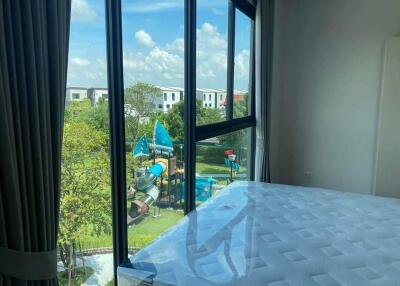 Bedroom with large windows and garden view