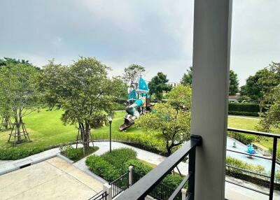 Balcony with a view of a playground and garden area