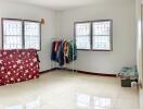 Spacious bedroom with tiled flooring and windows