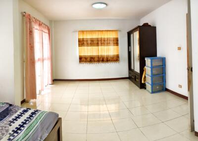 Spacious bedroom with large windows and ample storage