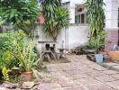 Well-maintained outdoor area with greenery and tiled patio