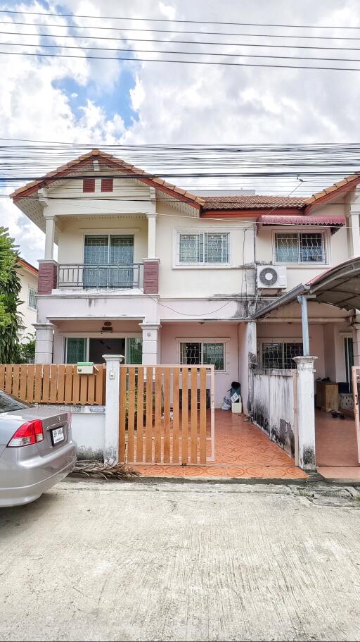 Two-story house exterior with driveway and car