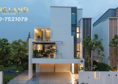 Modern facade of a two-story house with a garage and balcony