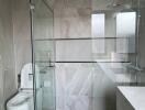 Modern bathroom with glass shower and toilet