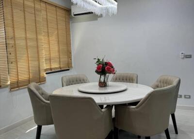 Dining area with a round table and six chairs