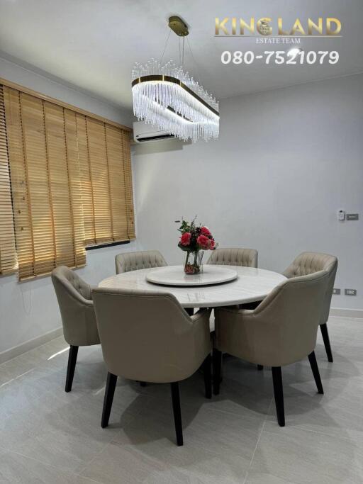 Dining area with a round table and six chairs