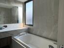 Modern bathroom with bathtub and large mirror