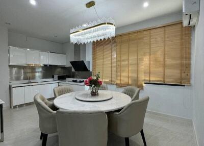 Modern dining area with round table and contemporary chandelier