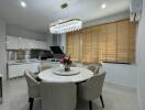 Modern dining area with round table and contemporary chandelier