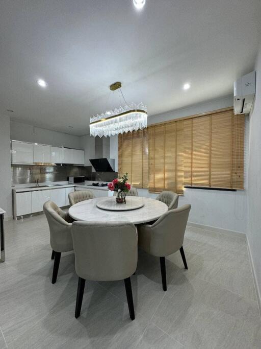 Modern dining area with round table and contemporary chandelier