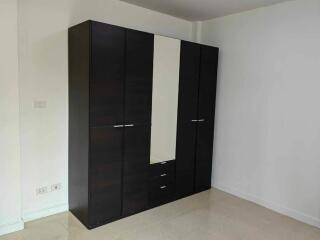 Bedroom with a large dark wardrobe