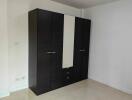 Bedroom with a large dark wardrobe