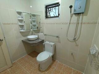 Modern bathroom with sink, toilet, and shower