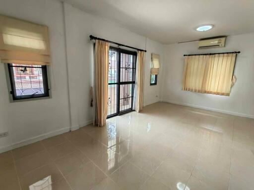 Bright and spacious living room with large windows and tiled floor