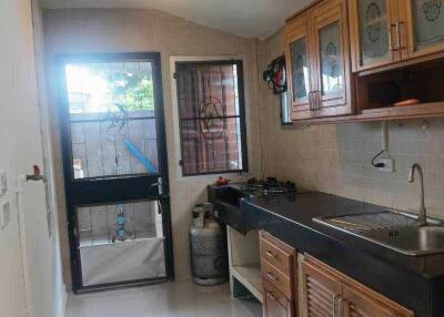 Modern kitchen with wooden cabinets and black countertops