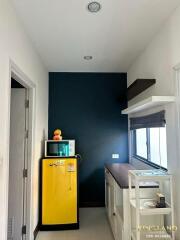 Small kitchen with yellow fridge and microwave