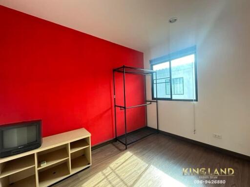 Minimalist bedroom with red accent wall