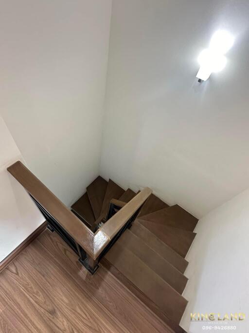 Indoor staircase with wooden steps and handrail