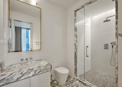 Modern bathroom with marble fittings and glass-enclosed shower