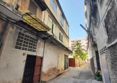 Exterior view of an old residential building and narrow alleyway