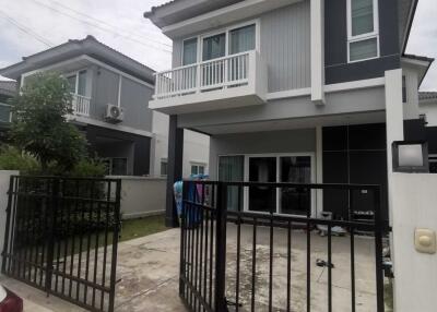 Modern two-story house with a gated driveway