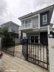 Modern two-story house with a gated driveway