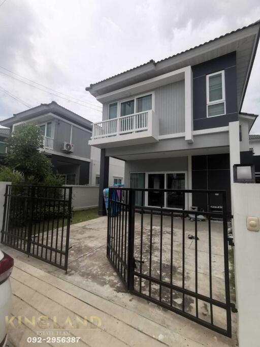 Modern two-story house with a gated driveway