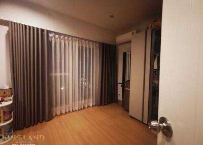 Bedroom with wooden flooring, curtains, air conditioning, and wardrobe