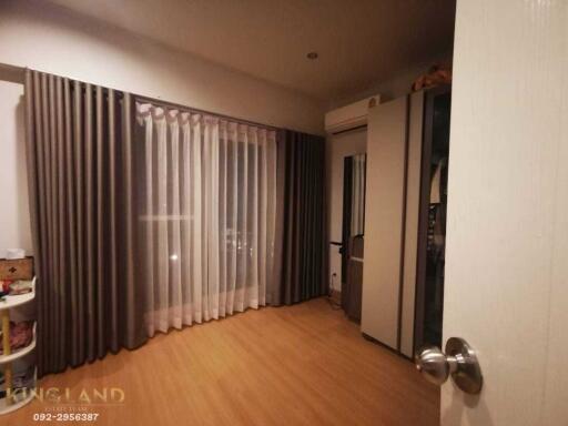 Bedroom with wooden flooring, curtains, air conditioning, and wardrobe