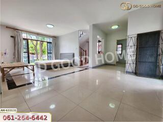 Spacious and well-lit main living area with large windows and modern furnishings