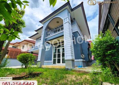 Exterior view of a two-story house with a garden